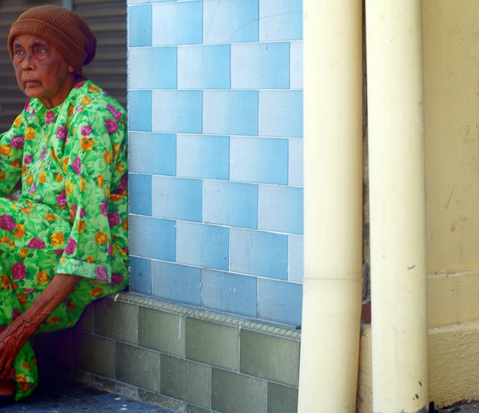 the woman in the colorful outfit has a big handbag