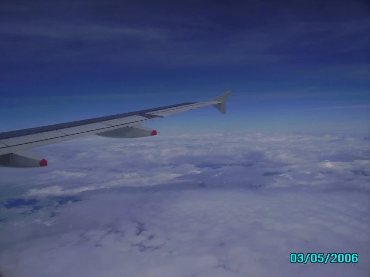 the view of the wing and some clouds