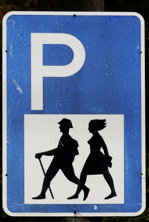 there is a parking sign with two people walking