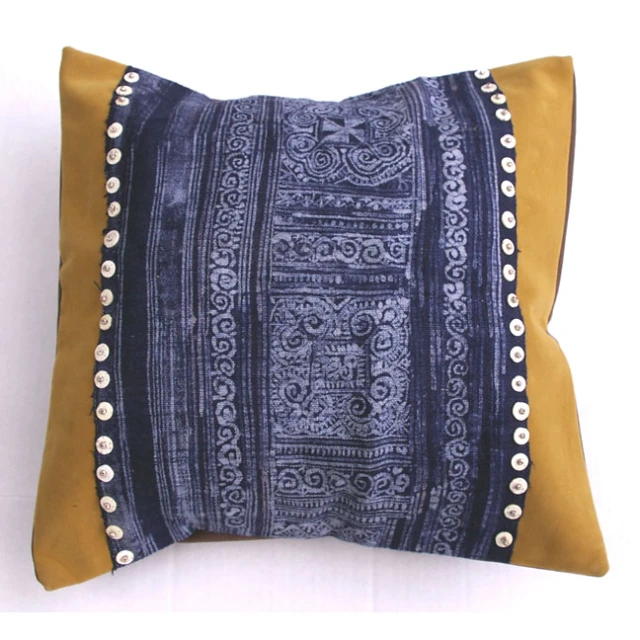 blue and yellow cushion with a design on it