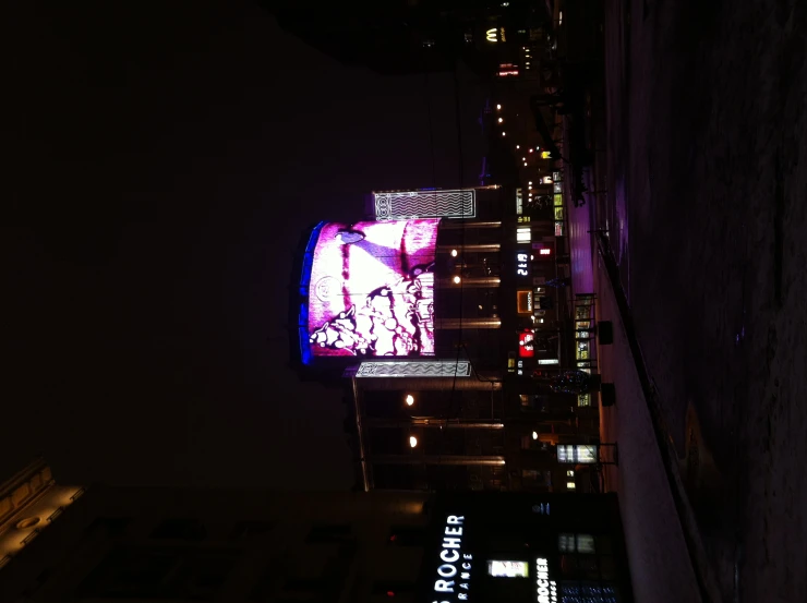 a building lit up with a large advertit