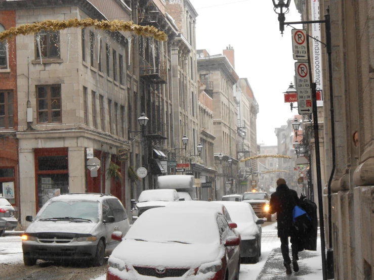 car and pedestrian traffic are covered in snow