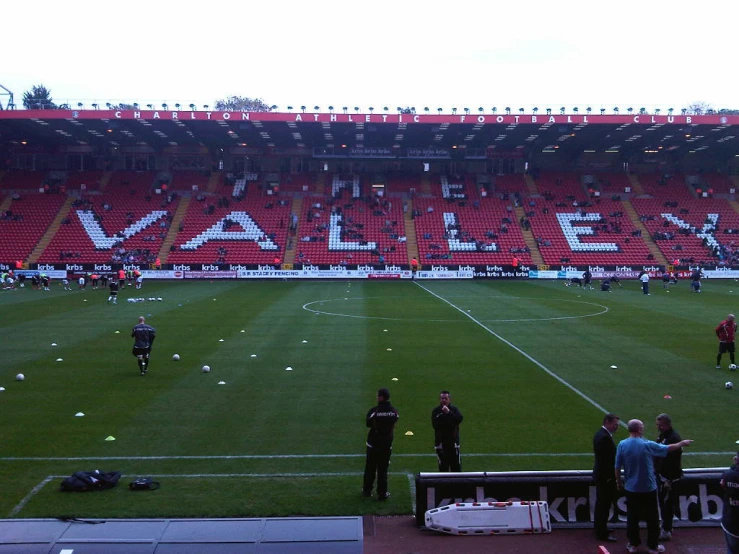 the stadium has many people playing soccer