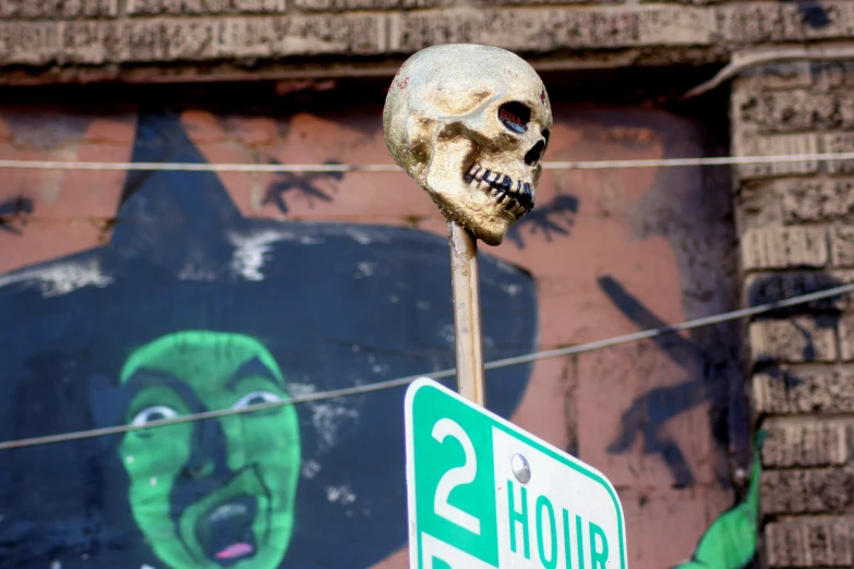 a sign has a skull head above it