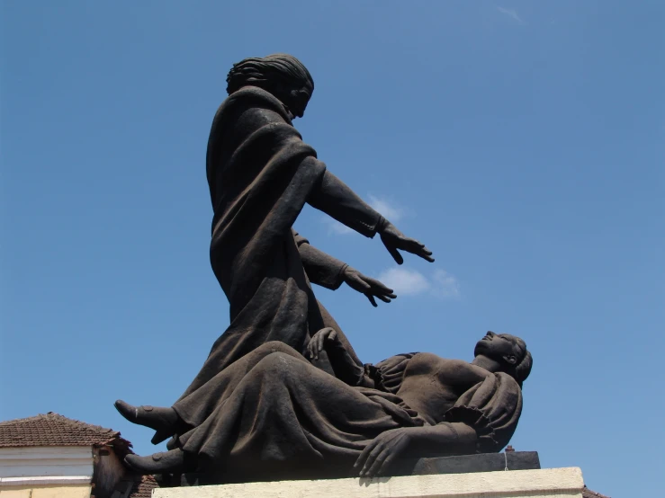 a statue of mother and child sitting next to each other