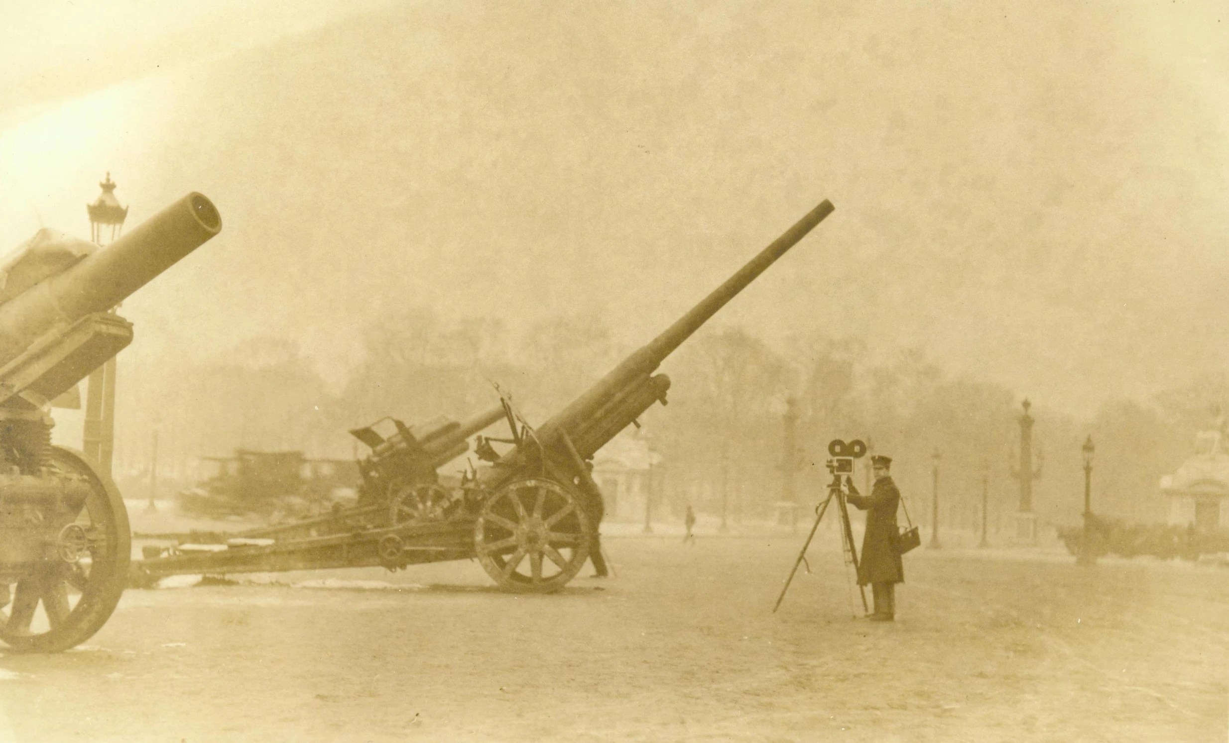 two old guns in front of an officer at a distance