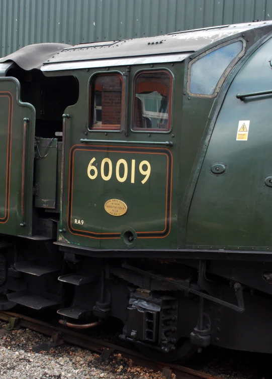 a old fashioned looking train that has numbers on the side