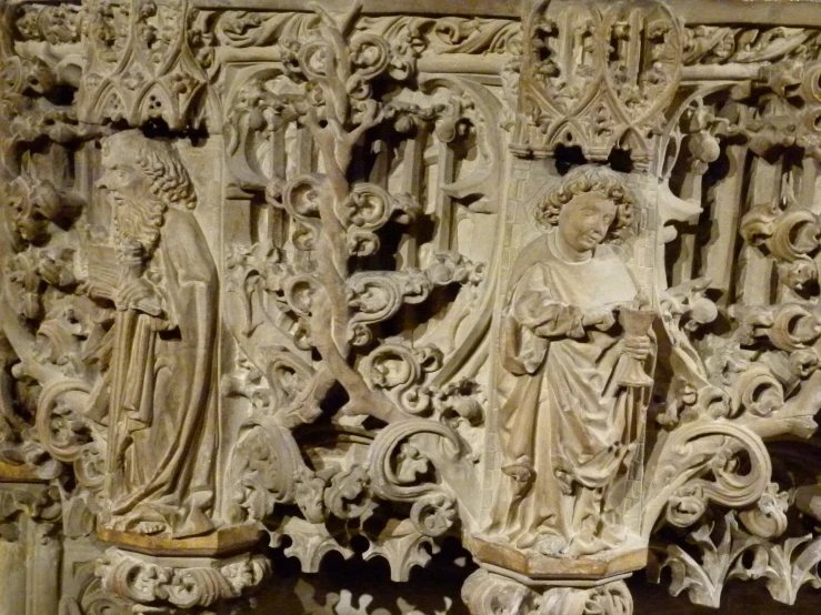 a carving is on the wall with many small figures