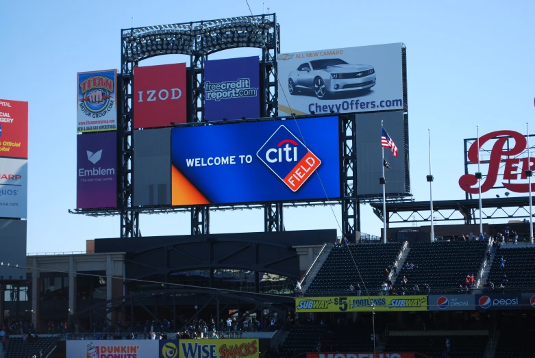 a stadium with several large advertits in it