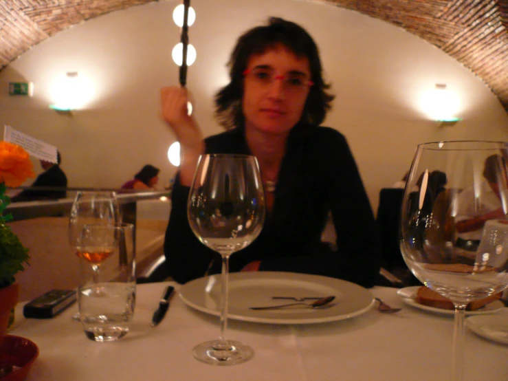 an image of a woman in the center of a restaurant setting