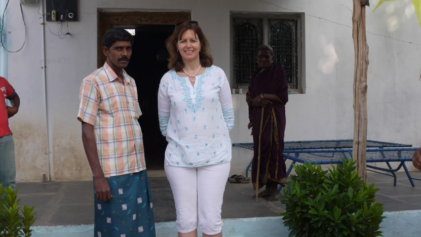 a couple of people standing in front of a house