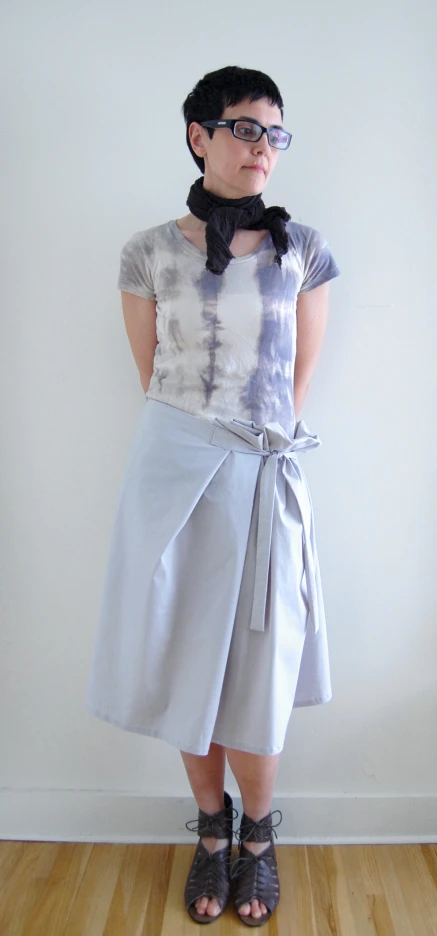 a woman in a gray tie dyed top and grey skirt