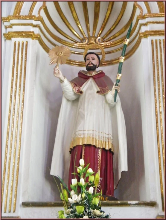 a statue of st nicholas holding an angel above a doorway