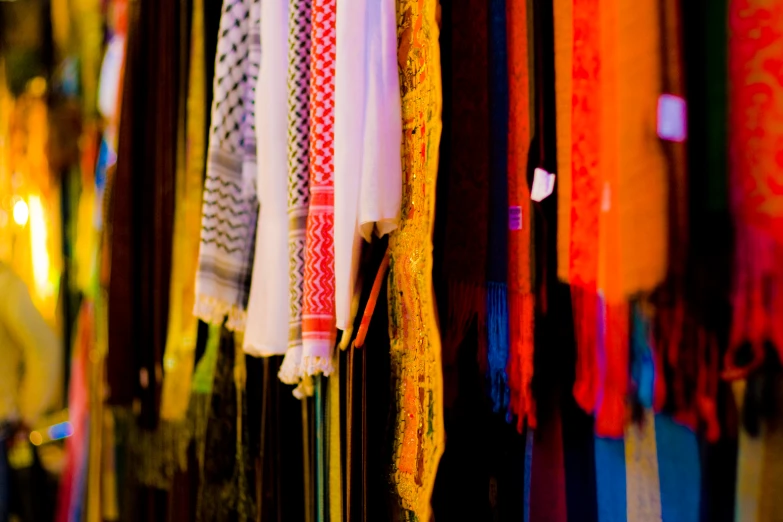 a display of scarves hanging from string to hang on wall