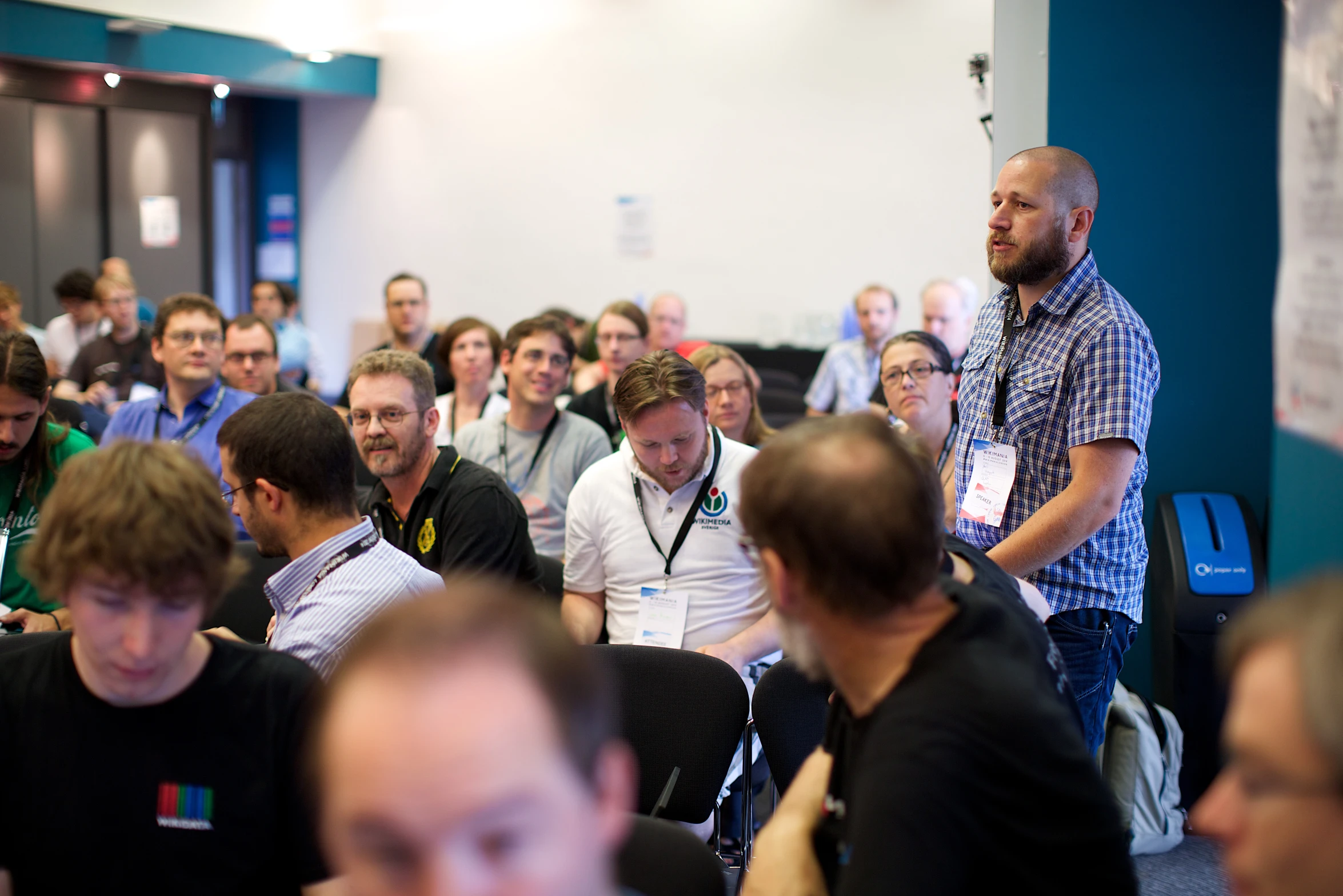 a large crowd sitting down listening to an expert