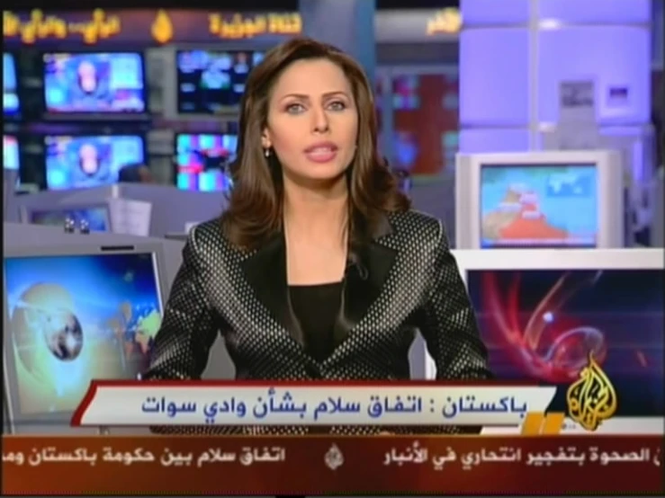 newswoman speaking in arabic at a tv station