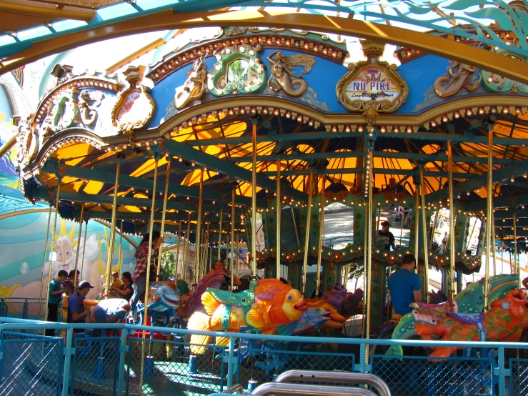 an animal - themed carousel at a carnival on a sunny day