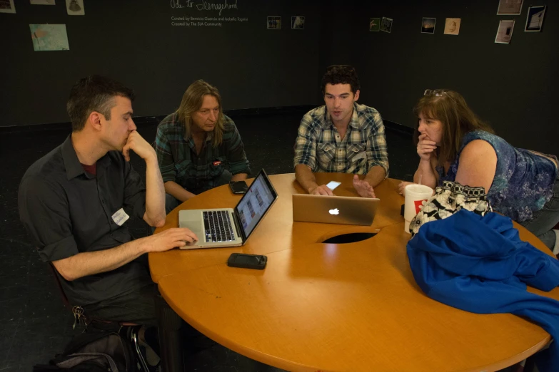 a group of people at a conference table sitting at a table