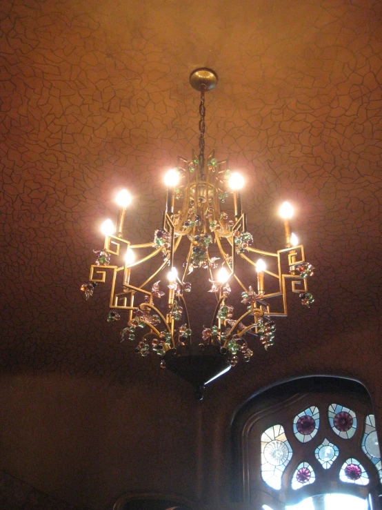 a small chandelier hangs from the ceiling in the room