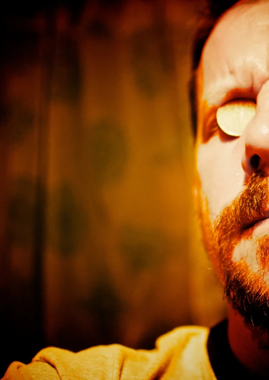 a close - up of a man with a beard and a cell phone