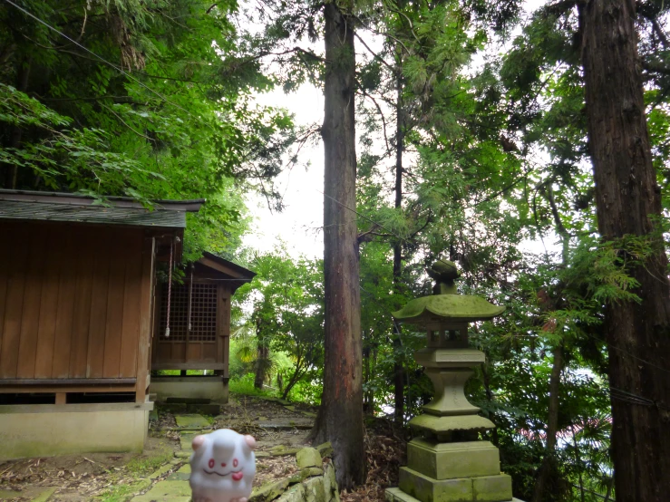 a stone tower sits in the middle of a park next to trees