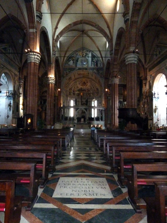 a church with black pews and red marble floor