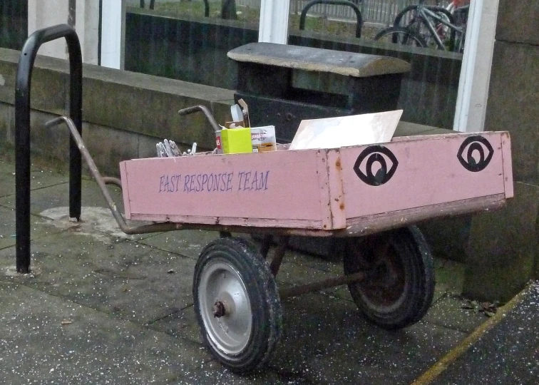 a pink cart that is outside of a store