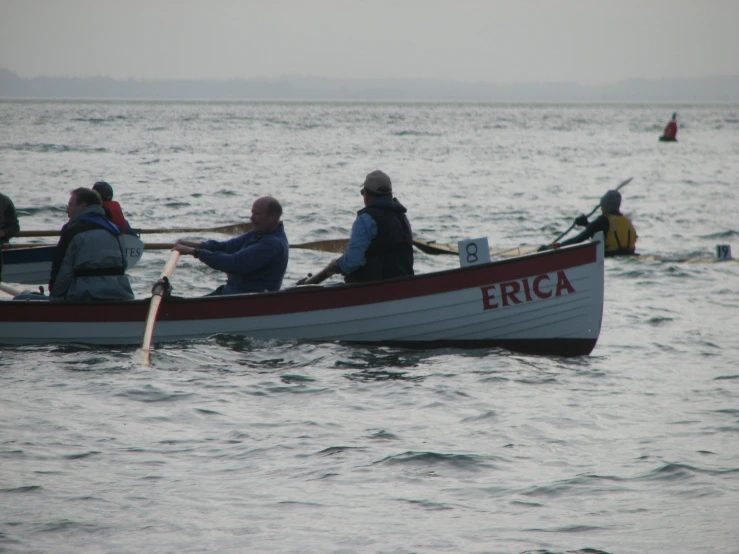 four people riding in a canoe on the water