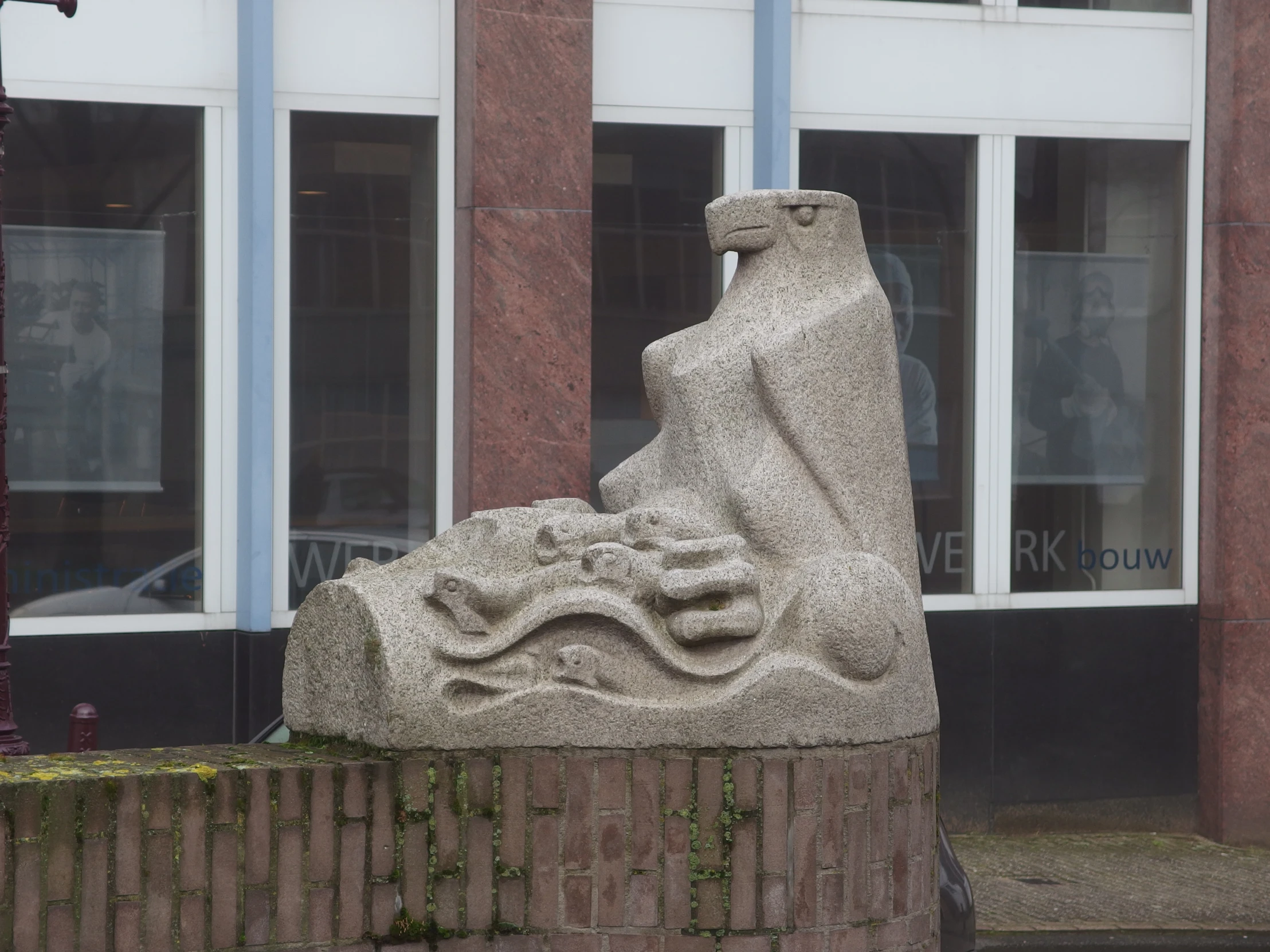 a sculpture is displayed outside of a building