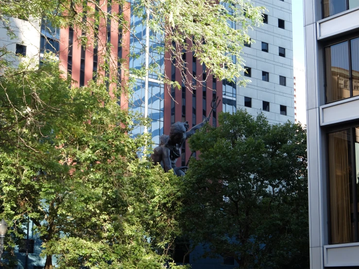 a tall building next to trees and a city street