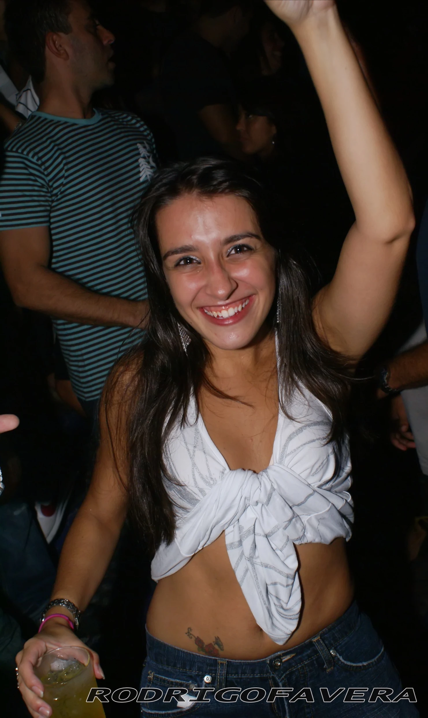 woman in a bikini holding a glass of beer at the party