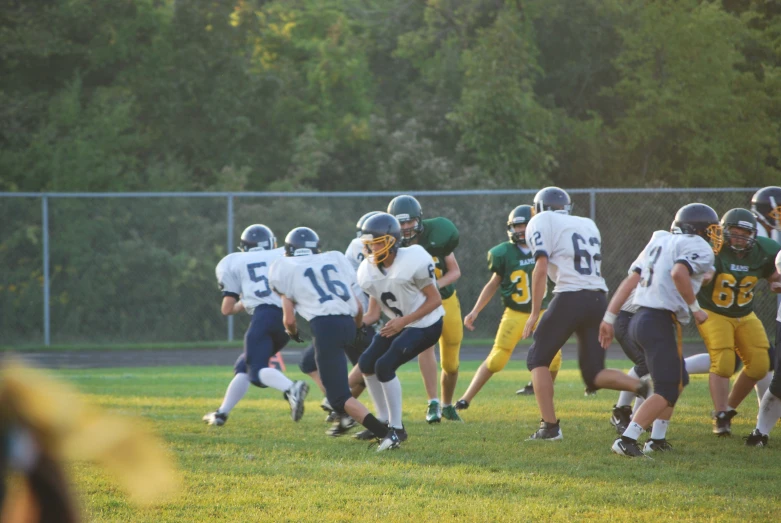 a group of young people playing football on a field