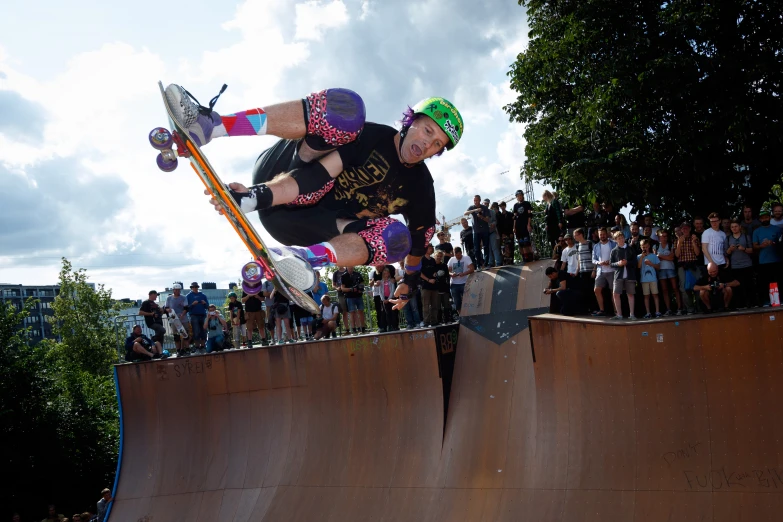 a guy on a skate board in mid air at a ramp