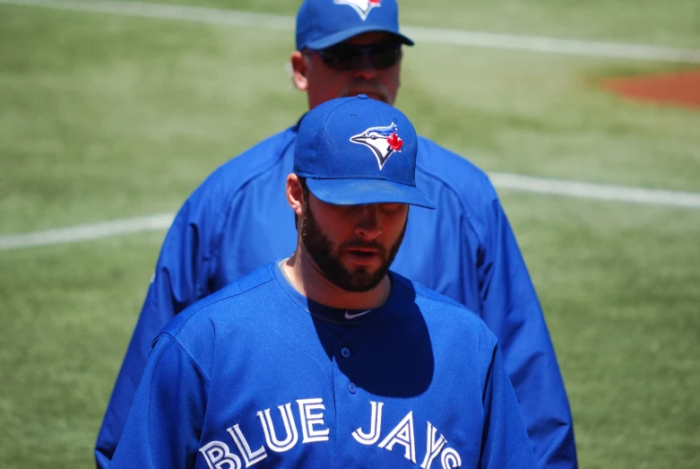 two baseball players are looking at soing,