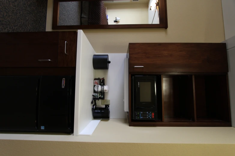 a small kitchen with black and brown cabinets