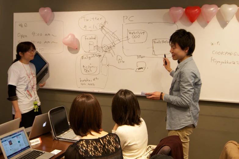 three people standing around talking to each other