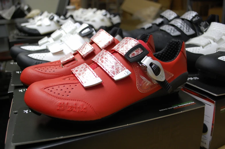 a pair of red shoes with metal straps on display