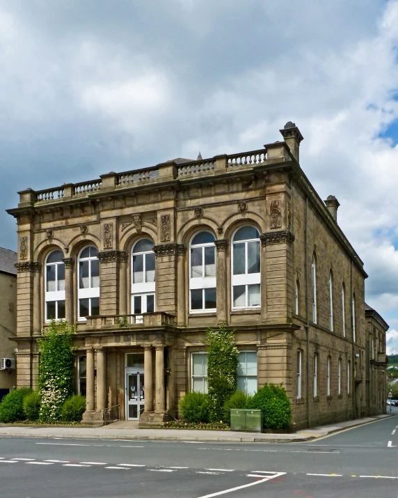 an old brick building with a white fence on it