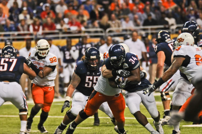 an image of a football game with the opposing team playing