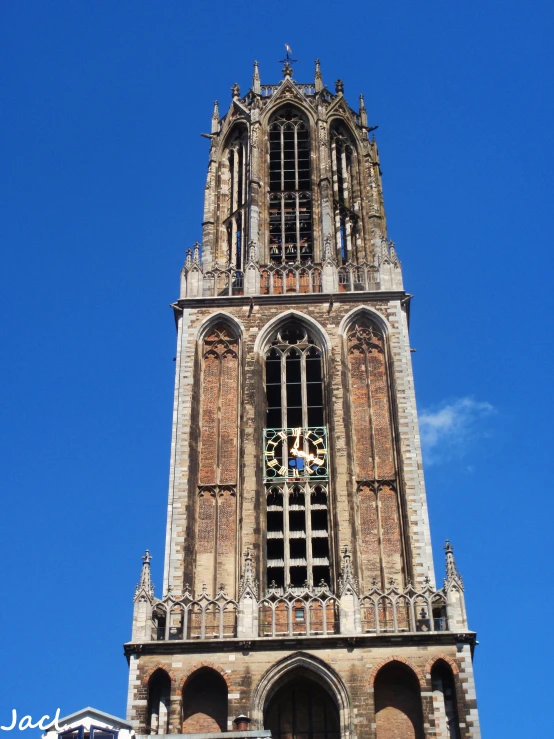 a tall clock tower with a massive tower with arches