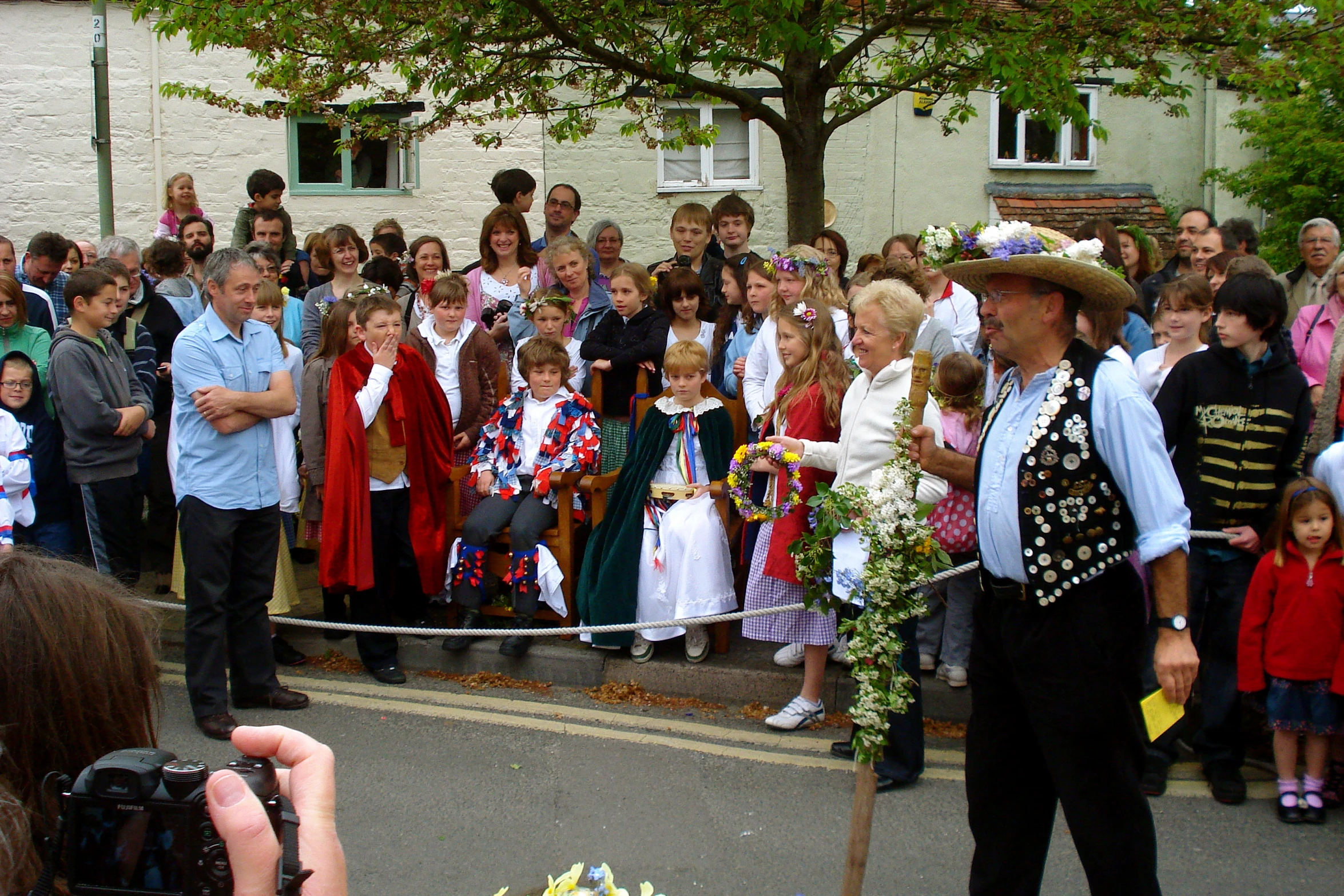 two people standing in front of the crowd at a parade