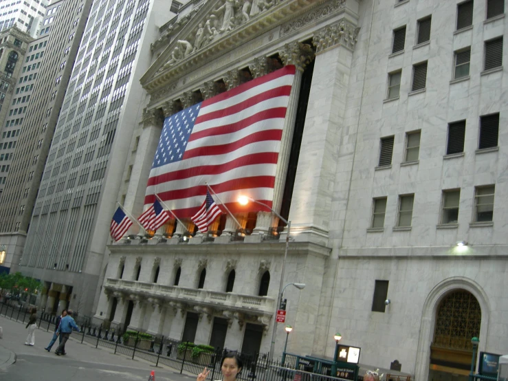 there are several flags that are on the building