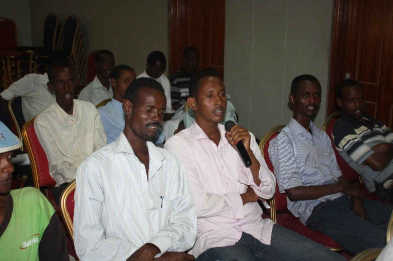 a man giving a speech with other people