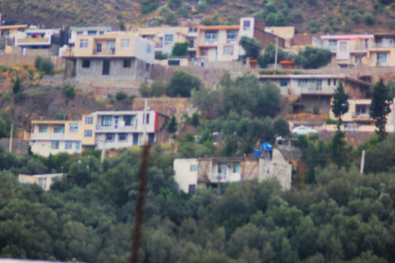 a view of houses with trees on the hillside