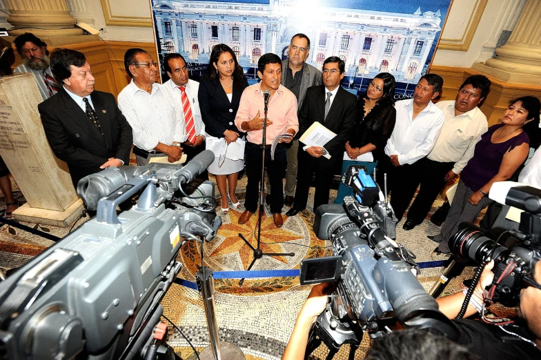 a group of people are standing in front of microphones