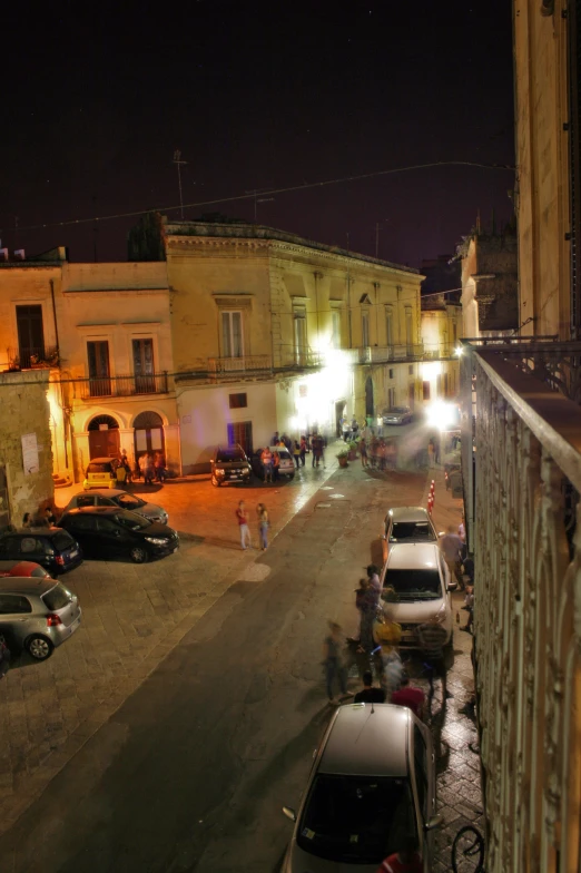 some cars are parked at a lot in the street