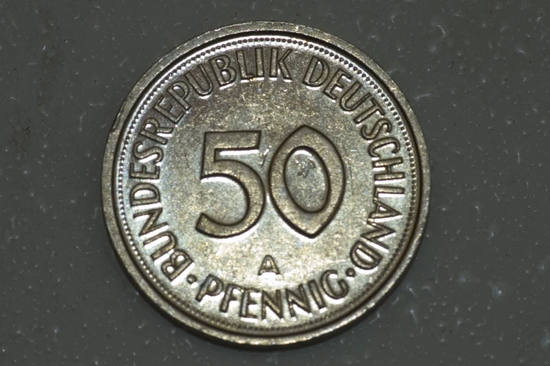 a coin sitting on top of a table covered in words