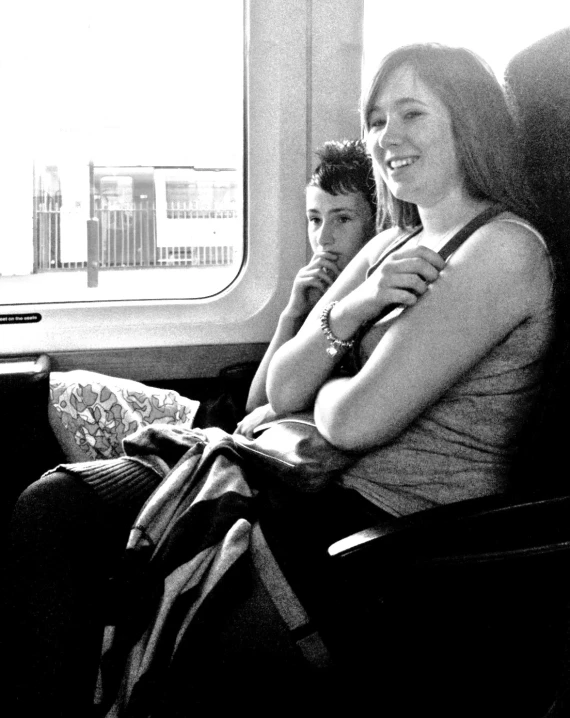 two woman on the train staring into the distance