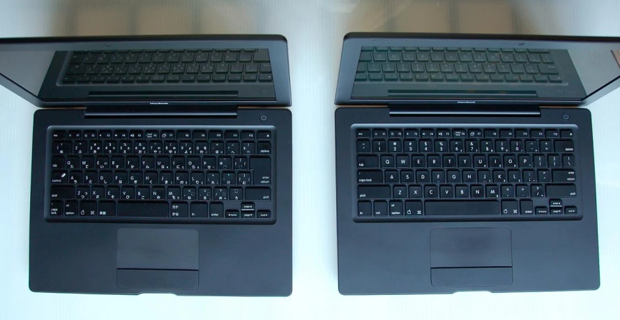 two computers sit on top of each other
