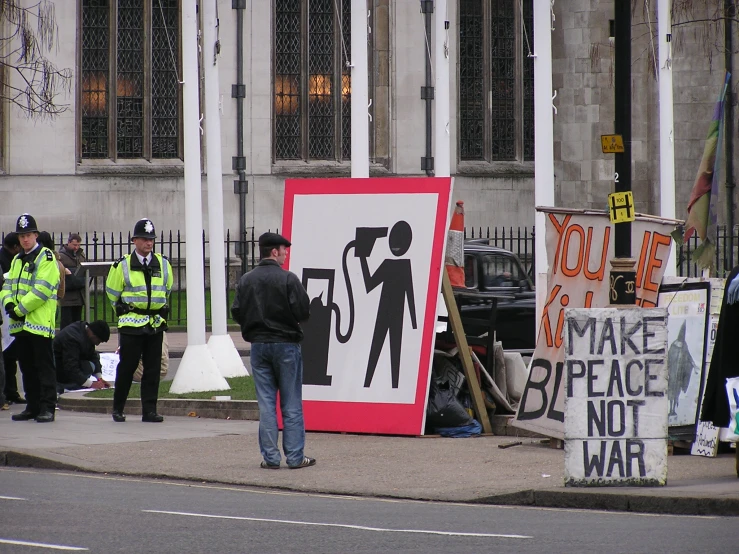 a protest on the side walk with signs